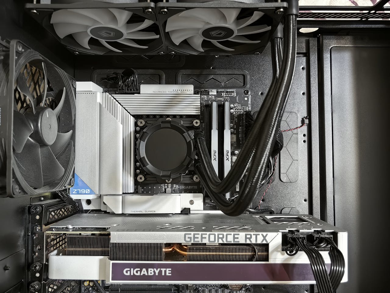 Detailed view of a custom gaming PCs interior showcasing components like RTX GPU and advanced cooling system.